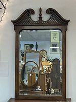 Full view of the Chippendale style wall mirror showing the shape, frame, and overall design reflecting the room interior.