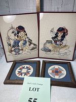Two 8x10 red metal framed Native American children cross stitch artworks and two 4x4 star quilt motif cross stitch artworks in dark wood frames, all positioned on a white wood background with a ruler for scale and a lot card in front.