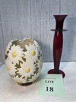 Photo showing both the midcentury daisy vase and the red glass candlestick together with lot number sign.