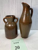 Both earthenware vases displayed side by side showing size difference and finish