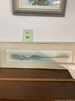 Full view of the elongated framed artwork showing sailboats on calm bay waters with background of green and blue hues.