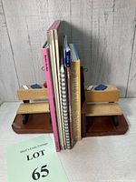 Two views of vintage wooden school teacher desk bookends with books and educational workbooks placed between them.