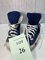 Front view of vintage navy blue Pro Keds high top sneakers with white laces and soles, showing lacing detail and tongue in place.