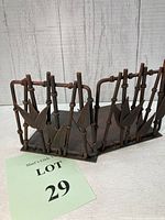 Full view of one bookend showing bamboo rod design and leaf elements in dark brown cast metal.