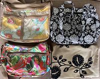 Three LeSPORTSAC purses with colorful and black-and-white patterns shown with IKEA embroidered cushion cover.