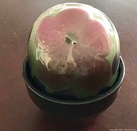 Flowerpot egg trinket box with reflective glazed floral lid and dark green base in closed position