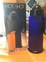 Photo of the Hot Shot thermal carafe next to its box showing the product and box design.