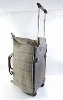 Side view of wheeled luggage showing plaid fabric sides, retractable handle, and wheels.