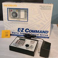 Photo of Bachmann E-Z Command Digital Command Control System box with DigiTrax DCS 60 control unit and power adapter placed in front.