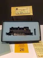 HO scale brass model of Baldwin side tank locomotive seated in foam inside original yellow box with label on lid.