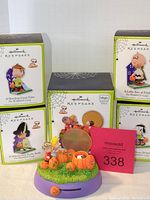 Full lot of Hallmark Keepsake Peanuts Halloween ornaments with boxes and musical Great Pumpkin base ornament.