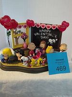 Complete front view of the Danbury Mint Peanuts Valentine's Day figurine showing characters, chalkboard, heart balloons, and base.