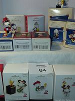 Eight boxed Hallmark Keepsake Collector's Series Snoopy and Woodstock ornaments shown with some out of boxes.