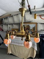 Full view of chandelier hanging, showing overall form and shade arrangement