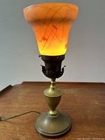 Lamp illuminated showing amber glow of aurene glass interior