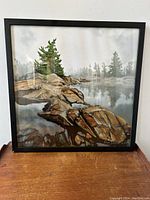 Framed digital oil painting showing rocky landscape and trees beside a lake with mist, signed by Dave Loblaw in the lower right corner