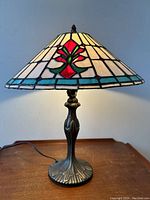 Full view of stained glass table lamp showing overall design and metal base.