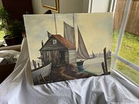 Front view of entire painting leaning on white cloth with window light