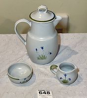 Photo showing the coffee carafe with green rim on lid, sugar bowl, and creamer, all decorated with blue floral designs