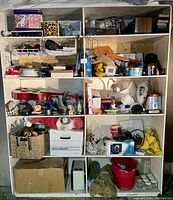 Wide shot capturing the full shelving unit with all assorted items displayed across five shelves.