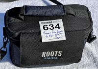 Black padded Roots Digital carrying case for camera with shoulder strap and lot label