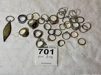 Photo showing full collection of costume rings with various designs, some featuring faux stones and intricate patterns.