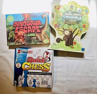 Photo showing three kids board games: Dinosaur Escape Game, The Sneaky Snacky Squirrel Game, and Quick Chess game with complete chess set.