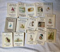 Photo showing all 15 Beatrix Potter books laid out on a surface, titles clearly visible on front covers.