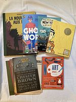 Photo showing six adult graphic novels including Ghost World, American Born Chinese, Louis Riel, a work by Julie Doucet, and others, with varied cover designs and colors.