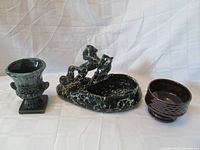 Three pottery planters displayed together, showing the size and color differences among them.