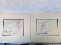 Two art prints by Sarah Malin side by side, showing the full prints and mats.