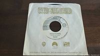 A 45rpm vinyl record titled 'Dave' by Cheech & Chong in a Gold Standard paper sleeve from WEA Music of Canada.