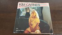 Front cover of Kim Carnes Bette Davis Eyes 45rpm vinyl single featuring a photo of Kim Carnes sitting on a couch.