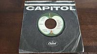 Front of the "Early 1970" single showing Capitol Records apple label and black paper sleeve with Capitol branding.
