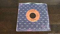 Photo of The Beatles 'Helter Skelter' 45 RPM vinyl single in MCA branded paper sleeve.