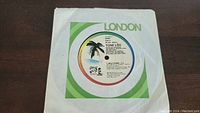 Top view of Tone Loc 'Wild Thing' 45 RPM vinyl record in paper sleeve with London Records logo and colorful label with palm tree on record label