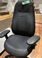 Front view of the black fabric Obus Forme office chair showing the seat, backrest, and padded armrests.