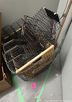 Photo showing a large collection of black wire organizers including filing dividers, a letter sorter, and wire baskets stacked together.