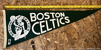 Large green vintage Boston Celtics pennant laid flat with measuring tape above for size reference