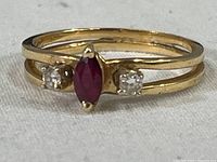 Front view showing marquise ruby center and flanking diamonds