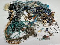 Overview of the mixed lot of costume jewelry including necklaces, earrings, and various accessories in multiple colors and materials.