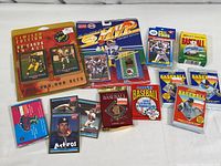 Wide view of all unopened vintage football and baseball trading card packs, with visible branding and player images on packs.