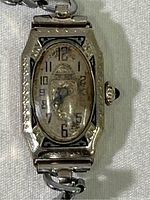 Front view of vintage Gruen ladies watch with an oval-shaped dial and visible wear.