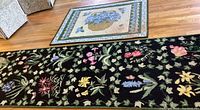 Overview of both rugs showing floral runner with black background and hydrangea basket rug.