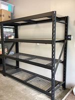 Front view of entire shelving unit showing all four grid shelves and frame