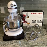 Front view of assembled mixer on rolling tray with mixing bowl and three beaters