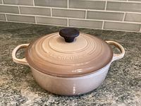 Front side view of enameled pot with lid on countertop