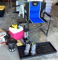 Photo of lot showing outdoor folding chair, cooler, lantern, flashlight, bug catcher, boots on boot tray