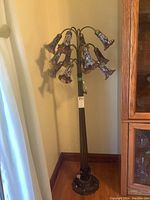 Full height view of the pewter-look metal floor lamp showing twelve curved arms and shades