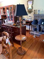 Full view of the Roxton floor lamp with integrated side table in a room with other furniture items visible